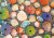 Puzzle image, depicting a variety of colorful seashells on sand
