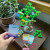 Central tree piece with many branches and blooms in place and a "Wind" card being drawn from a deck