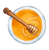 a top view of honey with a  honey stirrer