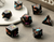 7 set dice on a table with black dice and butterflies and gold numbers
