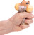 a hand squeezing the hamster to blew up its cheeks