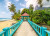 Puzzle image, depicting a beachside path with bright blue railings
