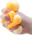 A hand squeezes an orange Wild Cat toy.