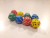 Eight 12-sided 1-6 dice in varying colors