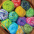 puzzle depicting a basket of colorful rolled yarn and knitting needles in a basket