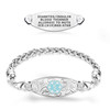 Image of a silver medical alert bracelet and a separate engraved medical alert tag displayed on a white background. The tag, positioned above, is oval-shaped with engraved text: 'DIABETES/INSULIN, BLOOD THINNER, ALLERGIC TO NUTS, ICE:(619)866-4768.' Below, the bracelet features a braided silver chain and a decorative oval plate with floral engravings. At the center of the plate is a light blue hexagonal medical emblem with a white Rod of Asclepius symbol. The design highlights both functionality and aesthetic appeal.