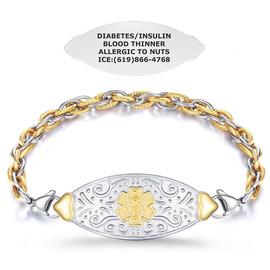 A two-tone metallic medical alert bracelet displayed on a white background. The bracelet features a central oval-shaped silver plaque with ornate embossed vine-like patterns and a raised gold Star of Life emblem in the center. The plaque is connected to a chain with interlinked silver and gold rings, with gold rings having a twisted texture. Above the bracelet, a separate silver tag is shown, engraved with medical information: "DIABETES/INSULIN, BLOOD THINNER, ALLERGIC TO NUTS, ICE: (619) 866-4768." The design highlights both the bracelet's elegance and its functional purpose for emergency medical identification. A two-tone metallic medical alert bracelet displayed on a white background. The bracelet features a central oval-shaped silver plaque with ornate embossed vine-like patterns and a raised gold Star of Life emblem in the center. The plaque is connected to a chain with interlinked silver and gold rings, with gold rings having a twisted texture. Above the bracelet, a separate silver tag is shown, engraved with medical information: "DIABETES/INSULIN, BLOOD THINNER, ALLERGIC TO NUTS, ICE: (619) 866-4768." The design highlights both the bracelet's elegance and its functional purpose for emergency medical identification.