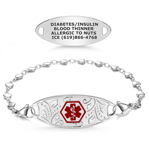 The image showcases a medical alert product, displaying both the front and back sides. The front features a decorative silver bracelet with a central oval tag adorned with intricate patterns and a red hexagonal medical alert symbol (Staff of Asclepius). The bracelet is complemented by a polished heart-link chain and lobster clasps for secure fastening. The back side highlights a plain silver oval tag with engraved medical information: "DIABETES/INSULIN, BLOOD THINNER, ALLERGIC TO NUTS, ICE (619)866-4768." This design combines essential medical functionality with an elegant and stylish appearance. The image showcases a medical alert product, displaying both the front and back sides. The front features a decorative silver bracelet with a central oval tag adorned with intricate patterns and a red hexagonal medical alert symbol (Staff of Asclepius). The bracelet is complemented by a polished heart-link chain and lobster clasps for secure fastening. The back side highlights a plain silver oval tag with engraved medical information: "DIABETES/INSULIN, BLOOD THINNER, ALLERGIC TO NUTS, ICE (619)866-4768." This design combines essential medical functionality with an elegant and stylish appearance.