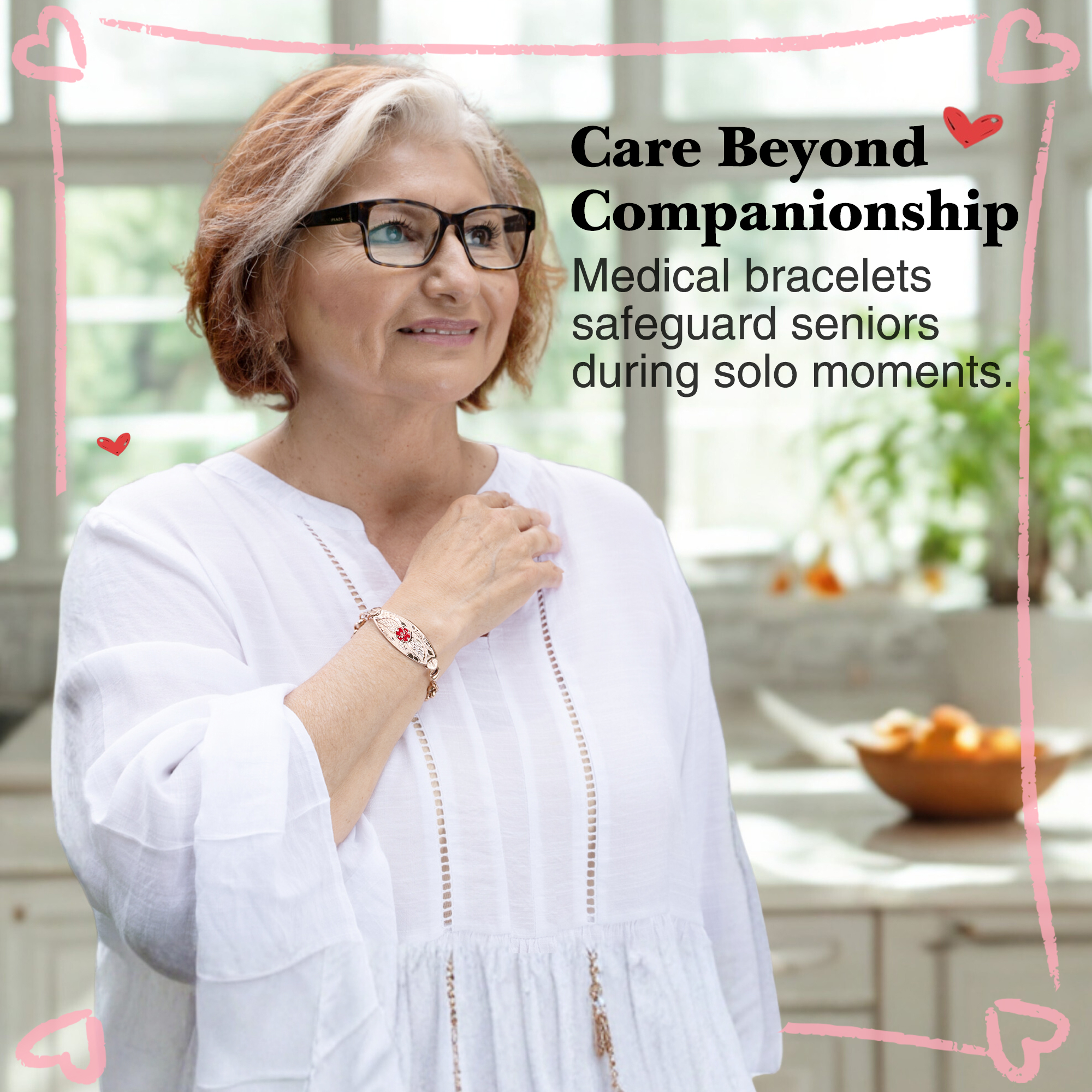 An older woman with reddish-brown hair wearing a gold-toned medical alert bracelet with a red emblem, gently smiling in a cozy indoor setting with a decorative pink heart border.