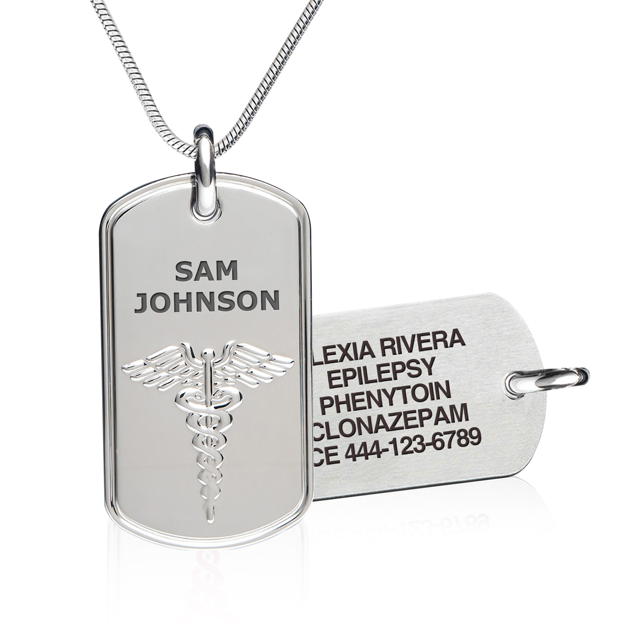 A silver dog tag-style medical alert necklaces are displayed against a white background. The foreground tag, suspended from a sleek silver snake chain, features the name "Sam Johnson" and a raised Caduceus medical symbol. The background tag, slightly out of focus, is engraved with additional medical details, including "Type II Diabetic," "Gastric Bypass," and an emergency contact number. Both tags have a polished, reflective finish, with their reflections visible on the glossy surface below.