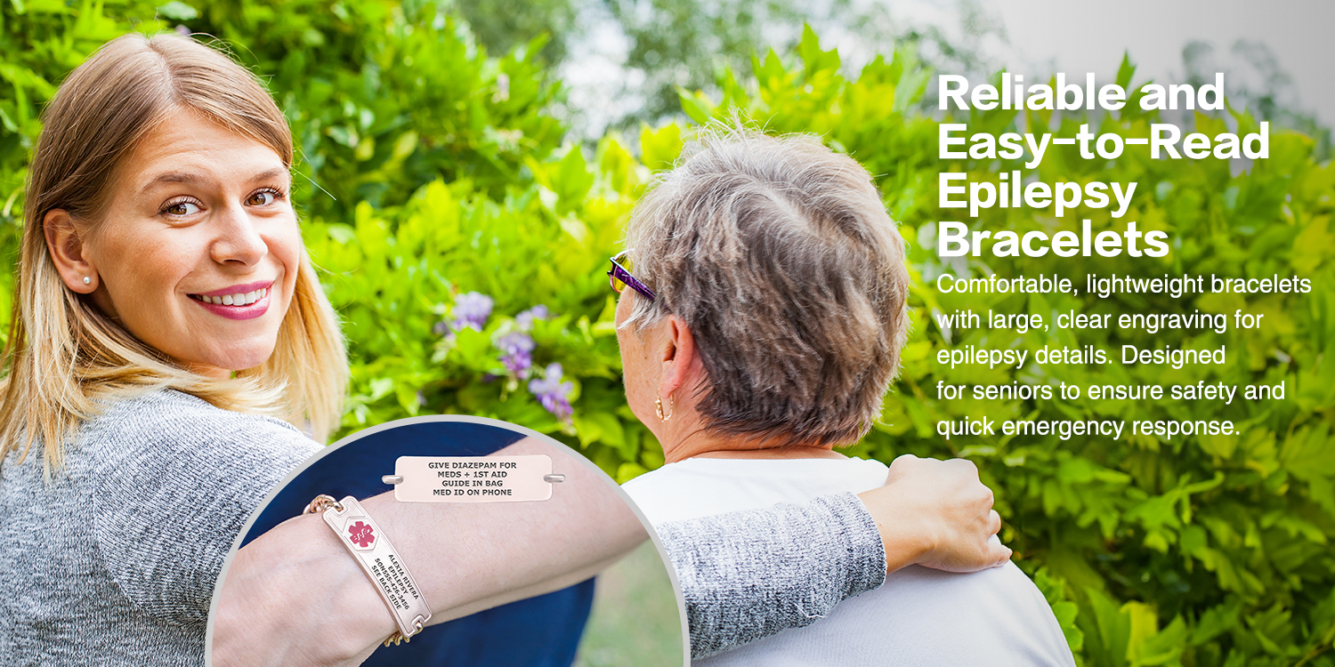 Two women are outdoors in a lush green setting with purple flowers in the background. The younger woman, with blonde hair and a grey sweater, smiles warmly while placing her arm around the shoulder of the older woman, who has short grey hair and purple glasses. A circular inset in the lower-left corner highlights a rose gold-toned medical alert bracelet with a red medical alert symbol and engraved details, including the name "Alexia Rivera," the condition "Epilepsy," an emergency contact, and a note to "See Back Side." The inset also shows a smaller tag with additional emergency instructions, such as "Give Diazepam for" and "Meds + 1st Aid Guide in Bag." Large white text in the upper right reads, "Reliable and Easy-to-Read Epilepsy Bracelets," emphasizing comfort, clarity, and safety for seniors.