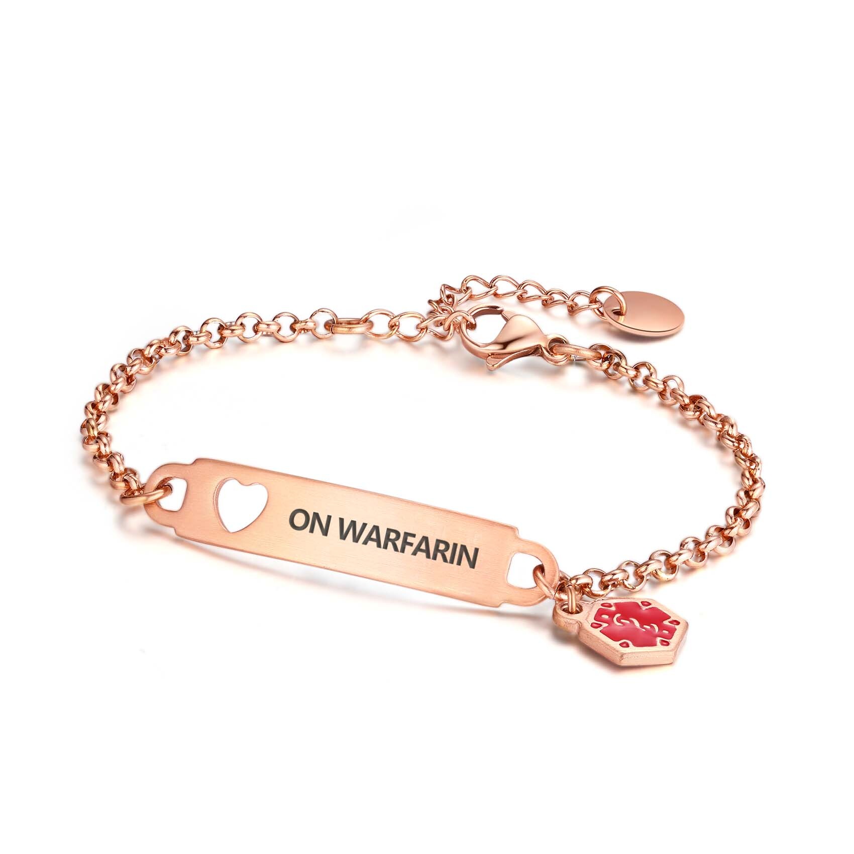 A rose gold medical alert bracelet with a rectangular tag engraved with "ON WARFARIN" and a heart-shaped cutout. The bracelet features a rose gold chain and a red hexagonal charm with a medical alert symbol.