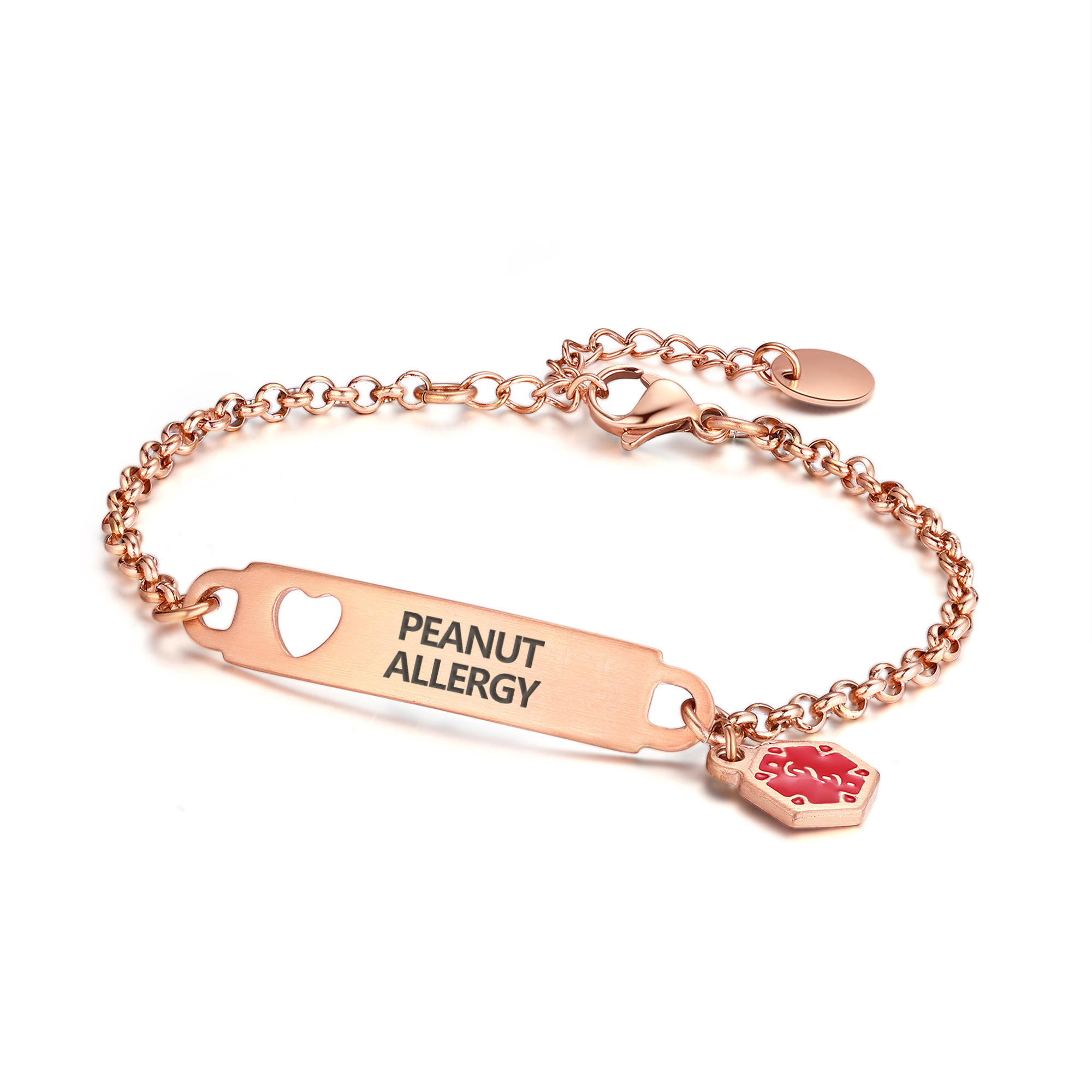 A rose gold medical alert bracelet featuring a rectangular ID bar engraved with "PEANUT ALLERGY" in black uppercase letters. The ID bar includes a heart-shaped cutout on the left and is attached to a delicate rolo-style chain. A red hexagonal medical alert charm with a rose gold border is connected to the right side of the ID bar. The bracelet also features a lobster clasp and an adjustable extension chain with a small oval tag, all displayed against a clean white background.