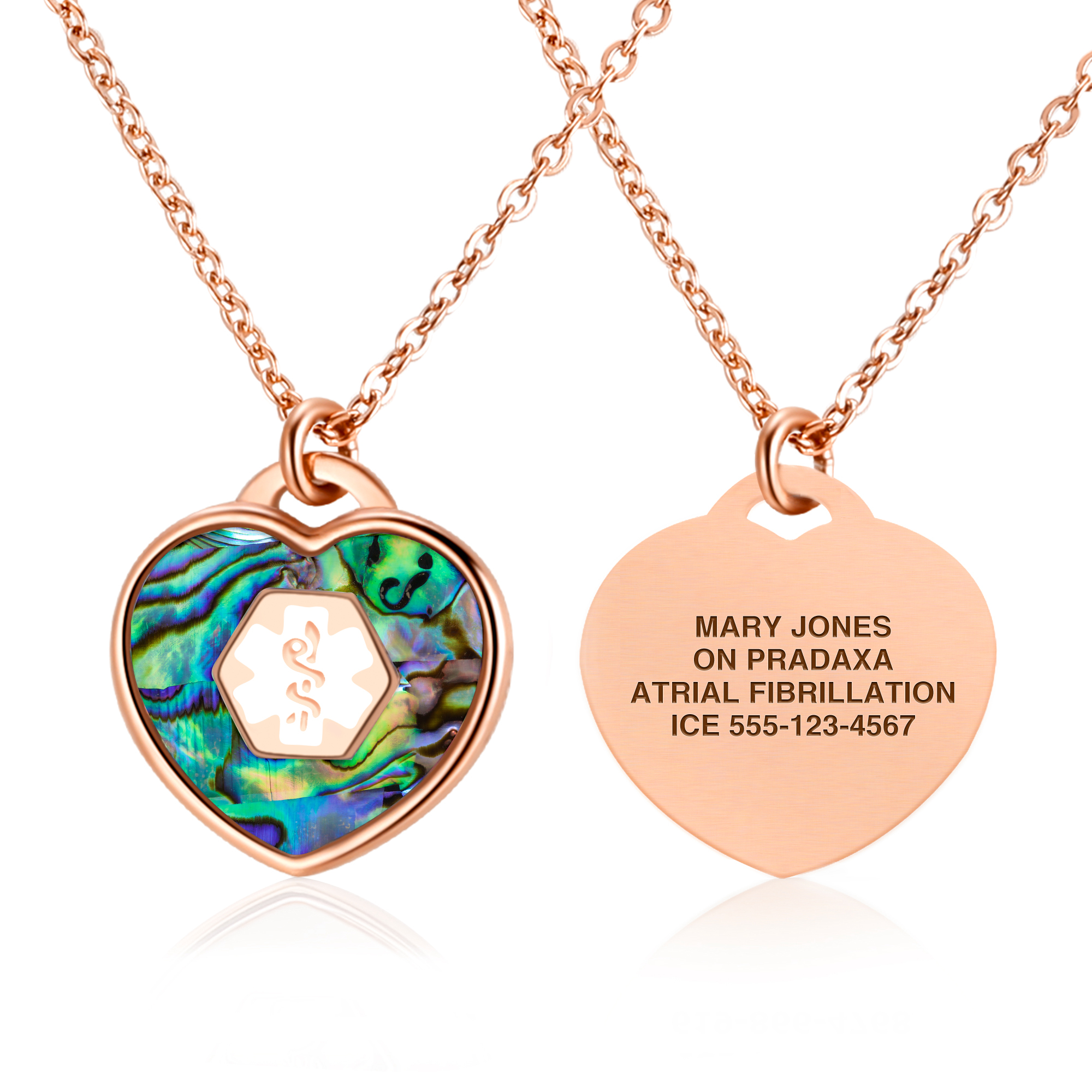 A rose gold heart-shaped medical alert necklace with an iridescent inlay on the front and engraved medical details on the back, including "On Pradaxa," "Atrial Fibrillation," and an emergency contact number.