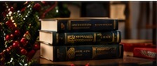 Christmas books arranged with evergreen branches and ornaments