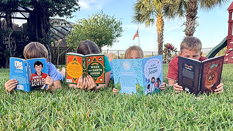 Children reading books together for the Ignatius Press Summer Reading Challenge