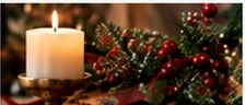 Christmas and prayer books with candlelight and evergreen