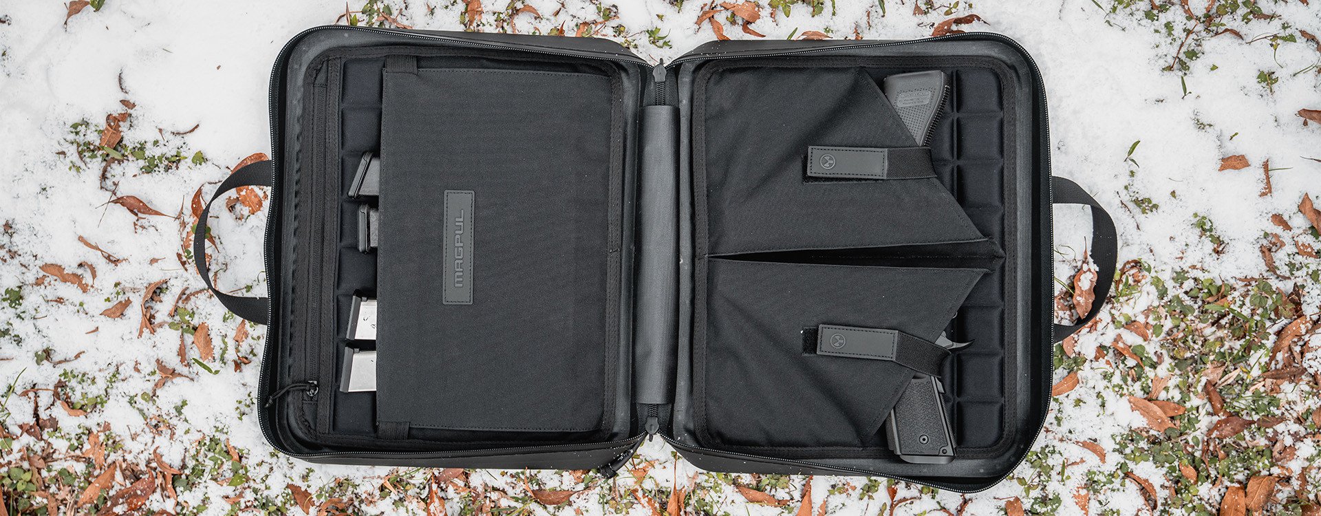 The DAKA Double Pistol Case is a large-format carrying case designed to secure and protect your firearms. The discrete, semi-rigid, double pistol case includes two large carrying handles, making it perfect for transporting and storing all sizes of pistols and their magazines.

The two internal panels are lined with a snag-free, protective EVA foam liner that adds a layer of security and a barrier against damage. On the left panel, there are two large pistol sleeves that can accommodate subcompact, compact, and full-size pistols. Each pistol sleeve has its own retaining strap that can stretch to accommodate a variety of pistol sizes. On the right panel, there are eight magazine retention bands and a large outer panel pocket to protect your pistols from contacting your magazines and causing damage. An additional zippered pocket can also be used to store documents, small tools, or cleaning items.

Constructed of durable DAKA material and featuring a water-resistant YKK® AquaGuard® zipper, a 550 paracord zipper pull, and a pull-tab that doubles as a carabiner pass-through, the DAKA Double Pistol Case is rugged, water-resistant, and the perfect storage solution for those times when one pistol is not enough.
