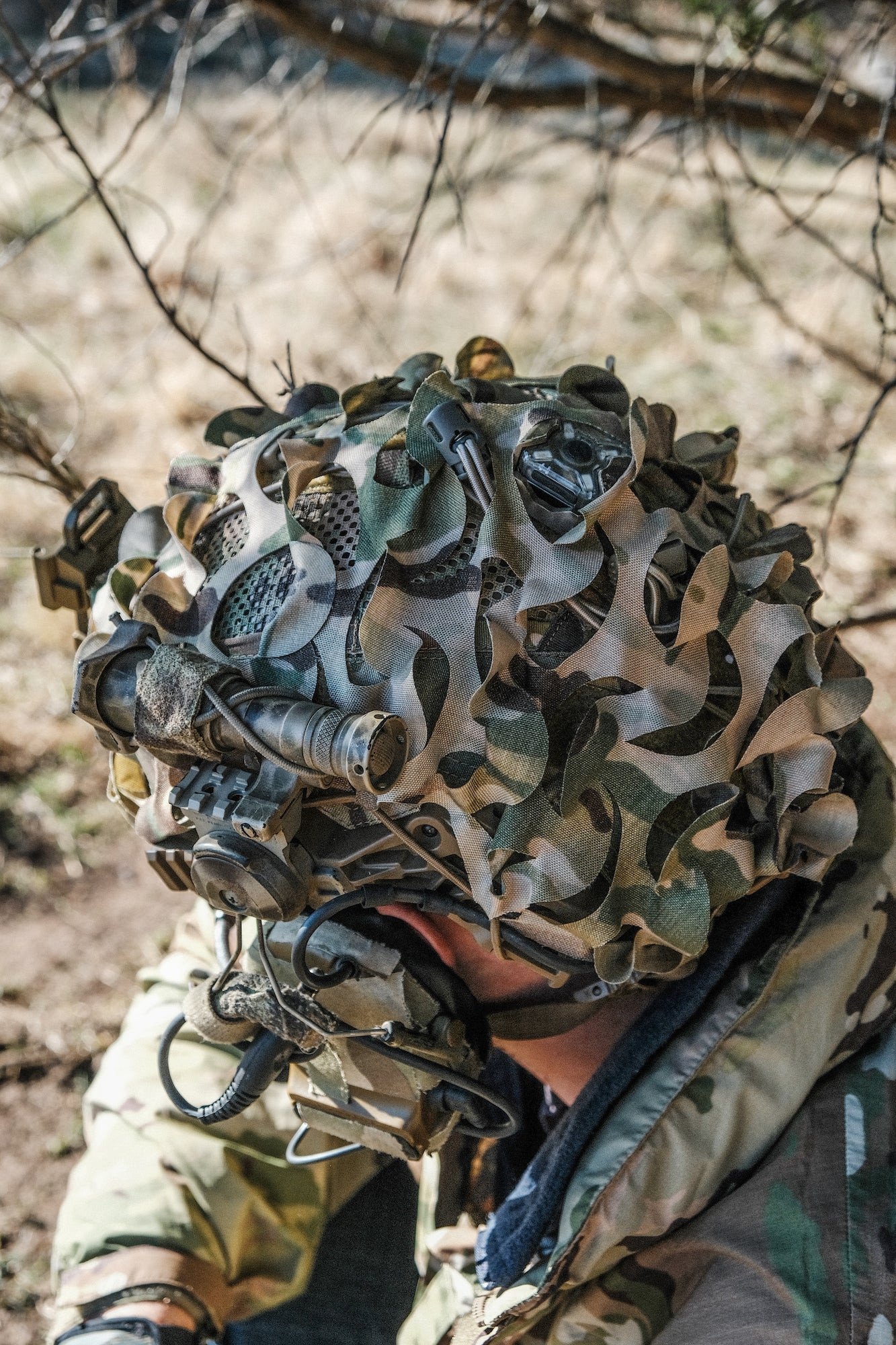 HelmetScrim attaches to your high-cut helmet, breaking up its silhouette and improving its camouflage in both the visible and IR spectrums. It attaches via a simple shock cord, stretching over your helmet, and has a rectangular cut out for your NVG mount. It is made in the US using licensed camouflage patterns and durable, NIR compliant materials.

