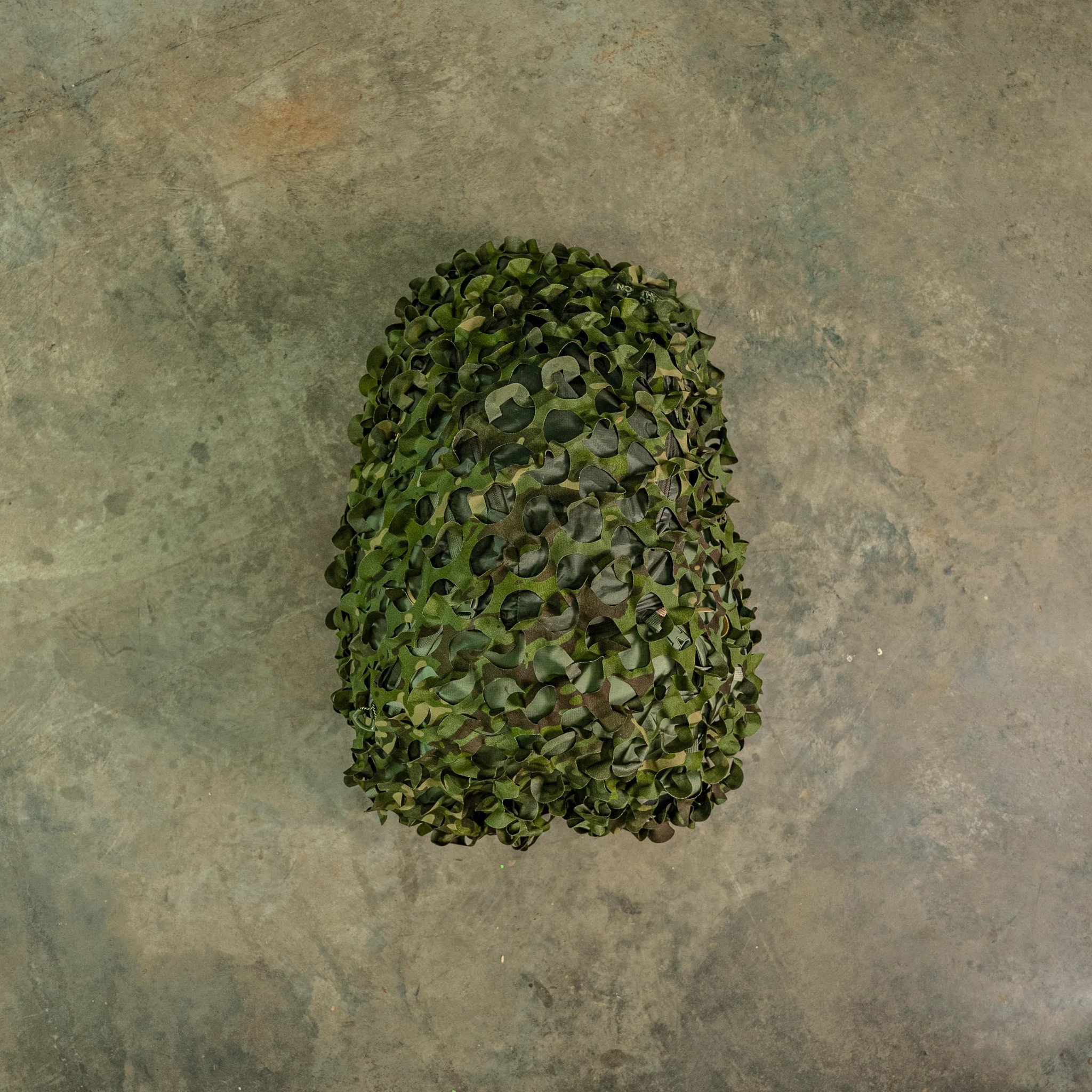 HelmetScrim attaches to your high-cut helmet, breaking up its silhouette and improving its camouflage in both the visible and IR spectrums. It attaches via a simple shock cord, stretching over your helmet, and has a rectangular cut out for your NVG mount. It is made in the US using licensed camouflage patterns and durable, NIR compliant materials.

