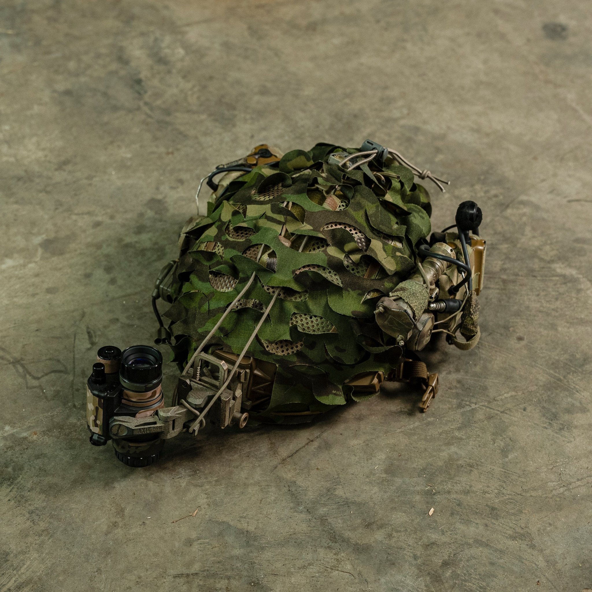 HelmetScrim attaches to your high-cut helmet, breaking up its silhouette and improving its camouflage in both the visible and IR spectrums. It attaches via a simple shock cord, stretching over your helmet, and has a rectangular cut out for your NVG mount. It is made in the US using licensed camouflage patterns and durable, NIR compliant materials.

