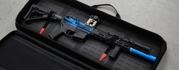 The Magpul DAKA Soft Case SC35 is a soft rifle case made from DAKA Grit material, making the case lightweight, flexible, durable, and weather resistant. The SC35 measures 35X3X12 and is designed to be used on those days when weight, speed, and flexibility matter the most. The cases two external YKK Aquaguard zippers are extremely rugged and include easy-grip 550 cord pulls that are reinforced with heat shrink-wrap for opening and closing the case. The case has a MOLLE-style base and includes four reconfigurable DAKA Gear Straps to secure a rifle, MOLLE-compatible pouches, or other gear. The interior of the lid features three stretchable mesh pockets to hold up to six PMAG LR/SRGEN M3 magazines, a mesh organizational pocket for small items, and a zippered pocket for smaller accessories and documents
