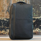 A sleek black backpack with a textured finish and a branding logo on the front.