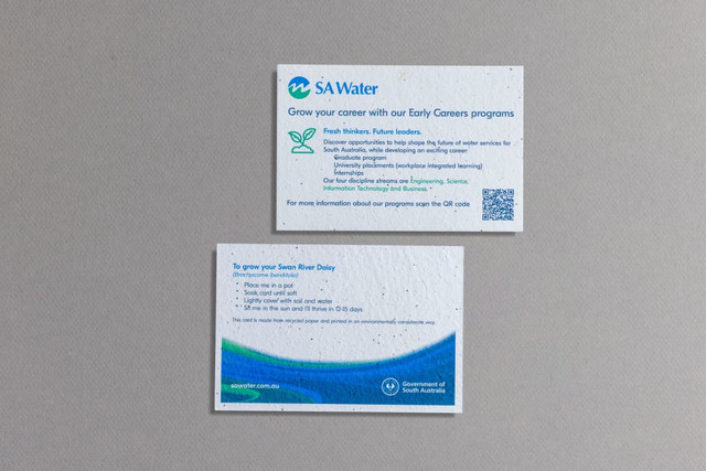 Two seed paper postcards, featuring a textured white surface with colours green and blue, and a logo on the top card.