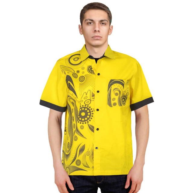 A bright yellow button-up shirt featuring a black patterned design on one side and a matching pocket.