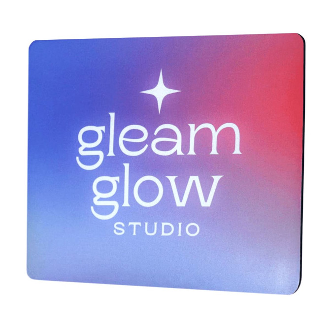 A mouse pad features a gradient design in purple and red, displaying a logo.