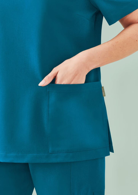 A women's teal V-neck scrub top featuring a side pocket, designed for comfort and utility in uniform apparel.