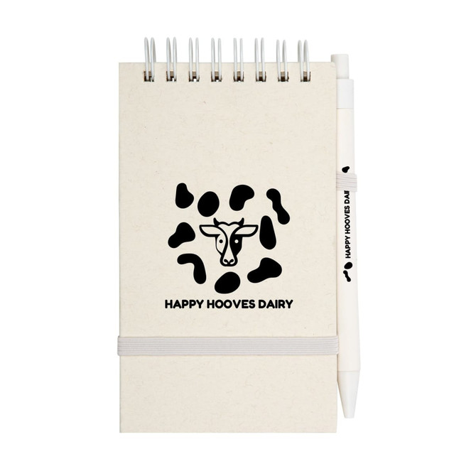 A spiral notepad with a tan cover and a pen, featuring a logo and a cow pattern design.