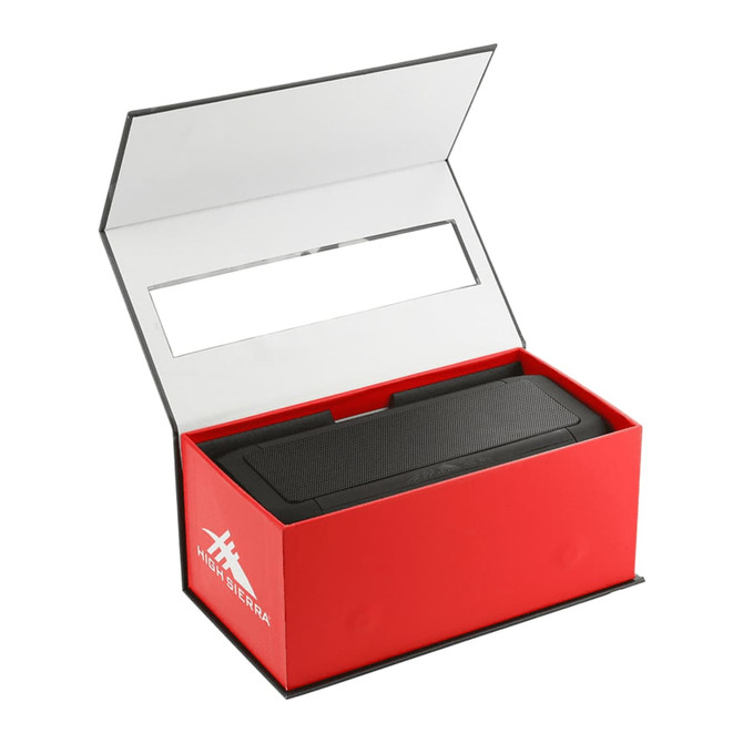 A black speaker and power bank inside a red box with a white interior and branding.