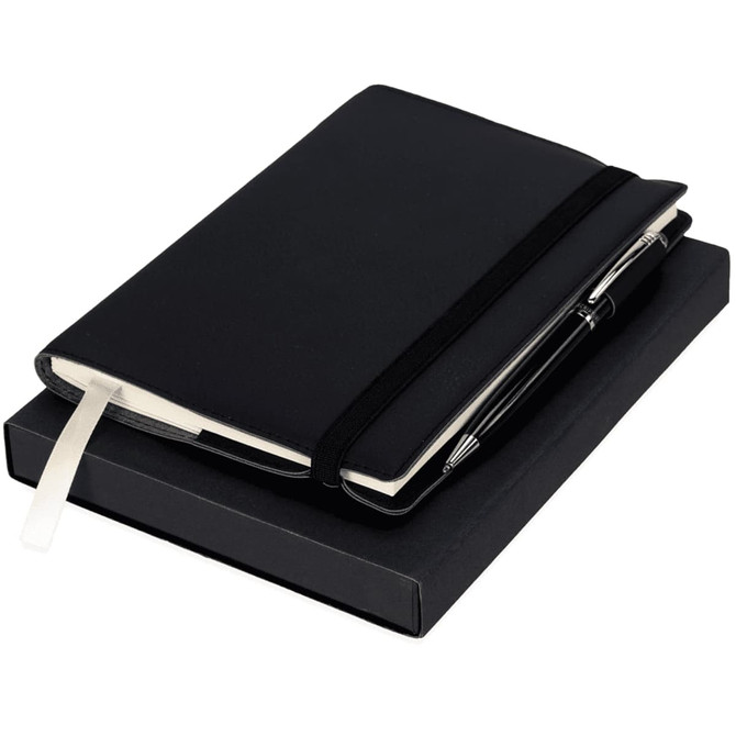 A black notebook with an elastic band and a pen, both presented in a black gift box.