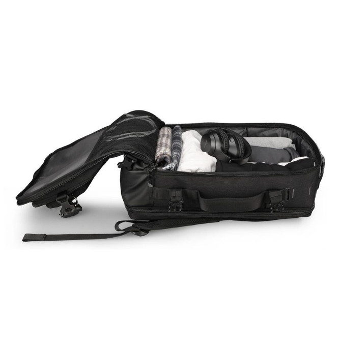 Open black travel bag packed with clothes and headphones.