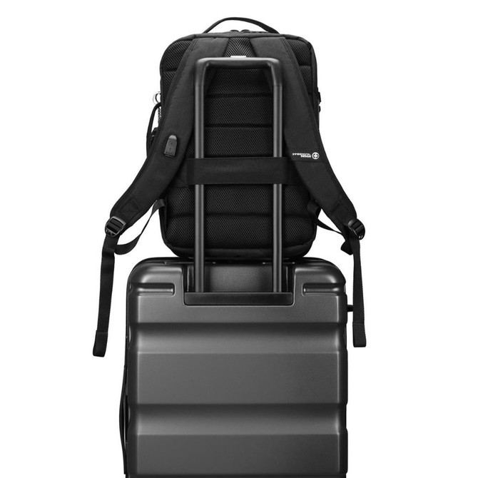 Backpack attached to luggage handle, convenient travel setup.