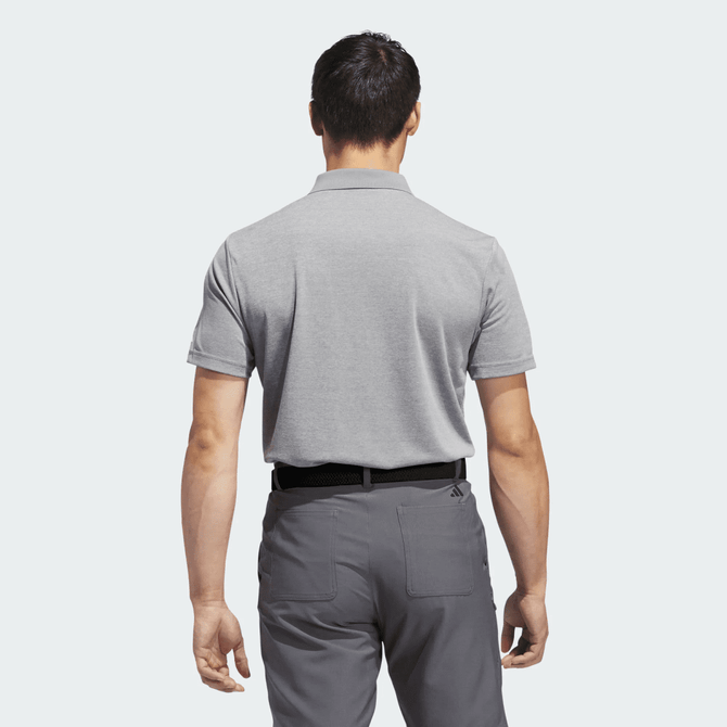 A grey polo shirt displayed from the back, featuring a collar and short sleeves. The shirt has a branding logo.