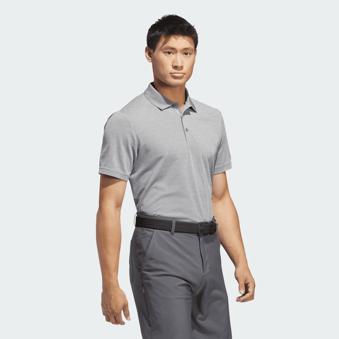 A grey polo shirt on a male model, featuring a collar and short sleeves, with a branding logo.