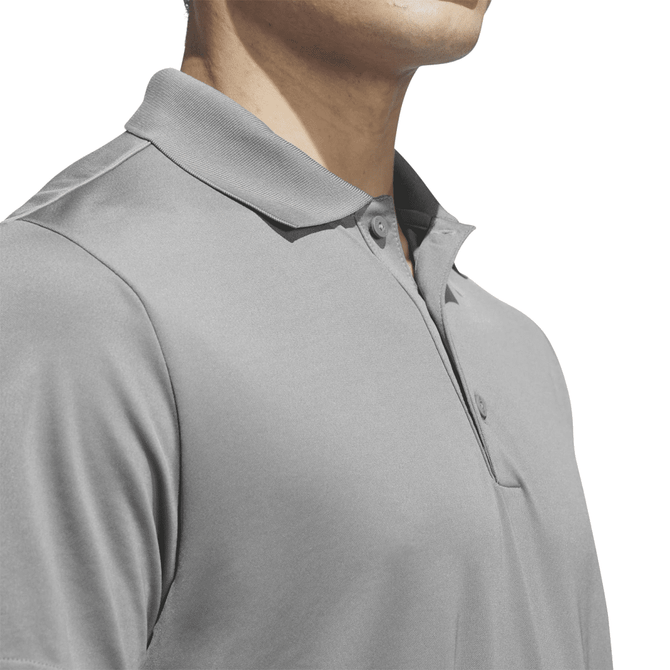 A grey polo shirt with a collar, featuring a logo, displayed on a mannequin's upper body.