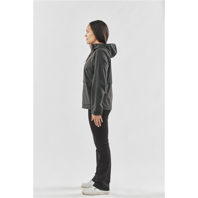 A woman wearing a black rain jacket with a hood, standing in profile against a plain background.