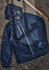A navy unisex super light packable rain jacket with a hood, featuring a zip front and a logo.