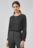 A black long sleeve blouse with a round neckline and a slight keyhole detail, paired with tailored trousers.