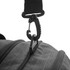 A close-up of a black duffle bag strap featuring a clip attachment and zipper detail.