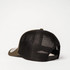 A green and black trucker cap featuring a mesh back and an adjustable strap. It includes a logo on the front.