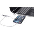 A 4-port USB hub in silver connects to a laptop with a phone attached, featuring USB-A and Type-C inputs.