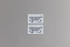 Two rectangular seed paper business cards in light grey with blue text and a circular logo, promoting sustainability.