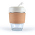 A reusable coffee cup featuring a transparent glass base and a white lid with a straw, encircled by a natural cork band.