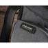 A grey backpack with a textured fabric and a logo patch. It features a zippered pocket and padded straps.