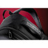 A black backpack featuring a textured strap and a logo. It has multiple compartments and zippers.