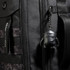 Black backpack with keychain accessory featuring cute black character.